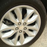 Before and after photographs of a damaged, black, Range Rover that was repaired by Elite Paint & Body Shop in West Palm Beach, FL.